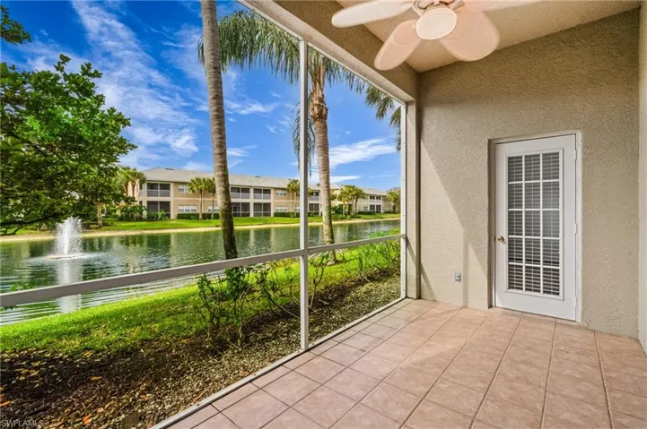 Unfurnished sunroom with ceiling fan and a water view