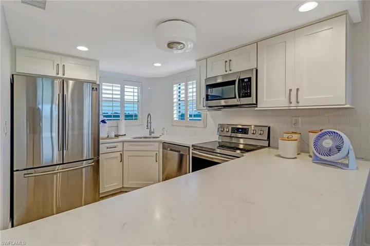 Corian counters, stainless steel appliances, white tile backsplash. Two windows to watch the sunrise.