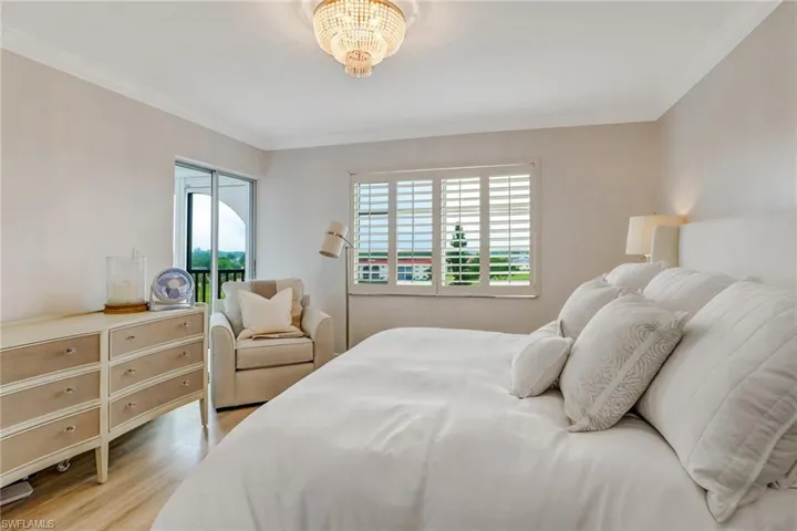 Master bedroom with sliding door to the lanai, laminate floors, plantation shutters.