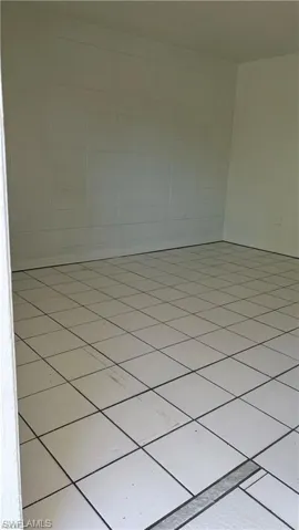 Unfurnished room featuring light tile patterned flooring