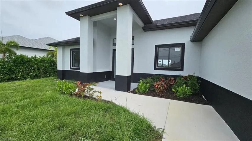 Doorway to property featuring a yard