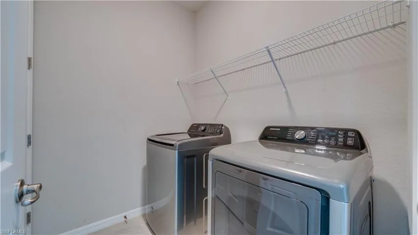 Laundry area with a wire shelf and light grey walls