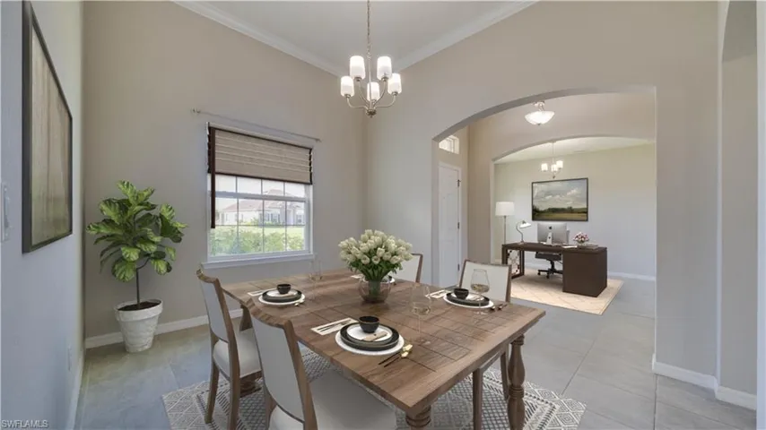 VIRTUALLY STAGED. This property features an inviting dining area with tiled flooring, an elegant chandelier, and a window providing natural light