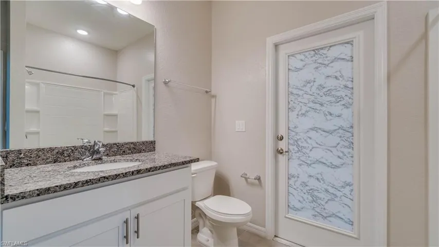 Cabana Bathroom with shower and access to outside area.