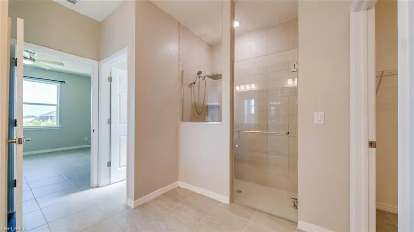 The house has a spacious walk-in shower with clear glass enclosure