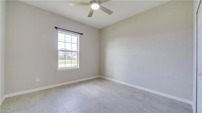 This room features light-colored walls and large format tile flooring
