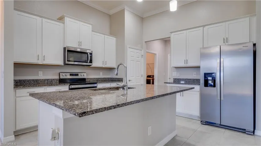 The kitchen features white cabinetry, granite countertops, a stainless steel appliances and a Pantry.  Easy access to laundry room and garage.