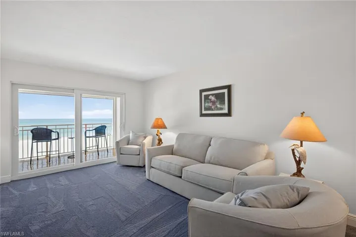 Living area with a water view and carpet floors