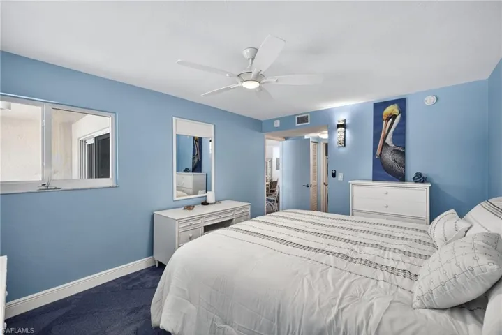 Bedroom featuring dark colored carpet and ceiling fan