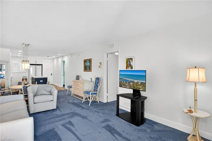 Carpeted living area featuring baseboards and recessed lighting