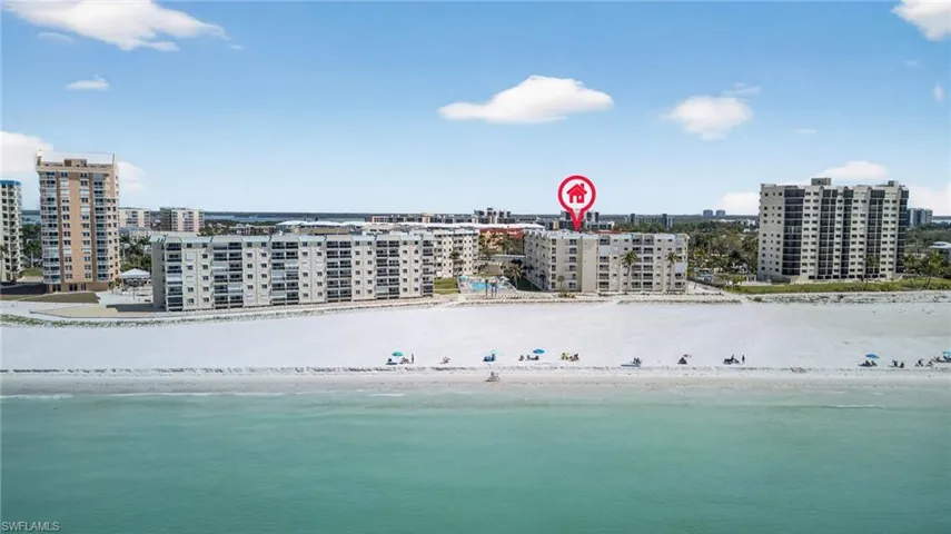 View of urban area featuring apartment complex / building and expansive beach
