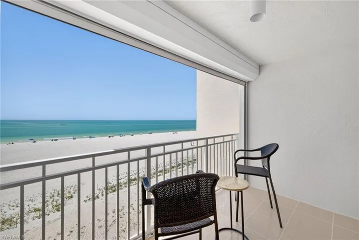Balcony with view of water and beach