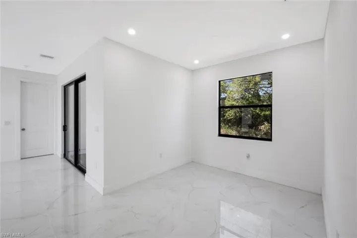Spare room featuring light marble finish floors and recessed lighting