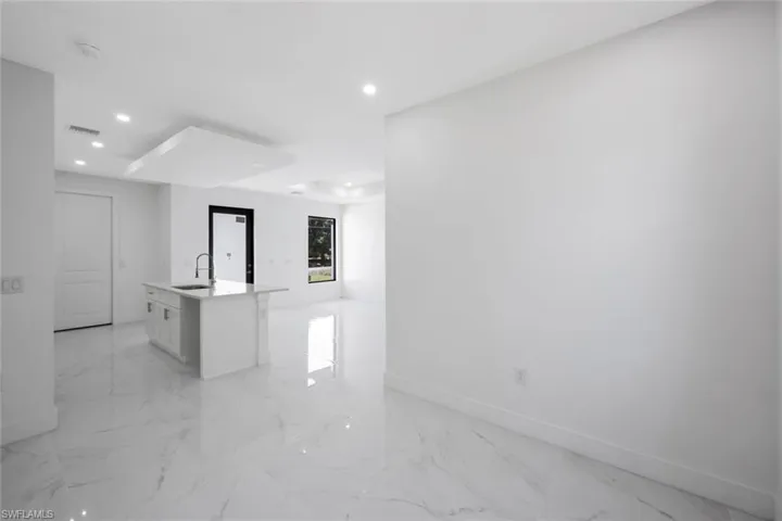 Unfurnished room featuring recessed lighting and light marble finish floors
