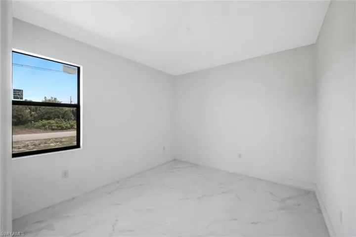 Empty room featuring light marble finish floors