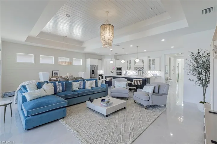 Living room with a chandelier and a tray ceiling
