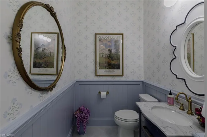 1/2 Bathroom featuring vanity and toilet