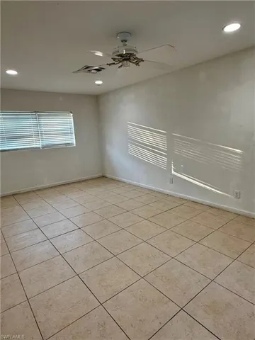 Unfurnished room with recessed lighting, light tile patterned floors, and ceiling fan