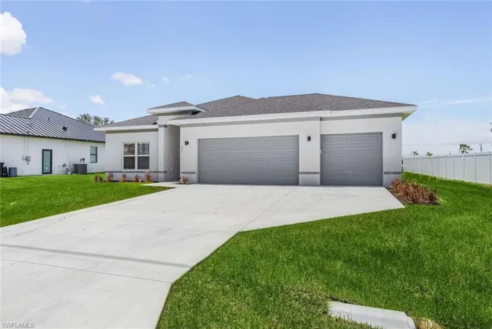 View of front facade featuring stucco siding, an attached garage, driveway, a shingled roof, and a front lawn