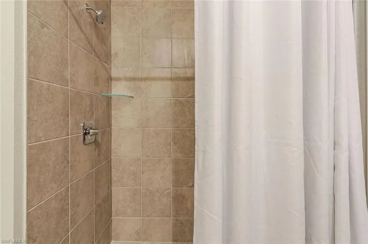 Bathroom with a shower with shower curtain