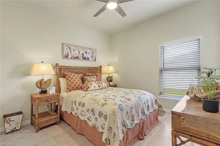Bedroom featuring light tile patterned floors and ceiling fan