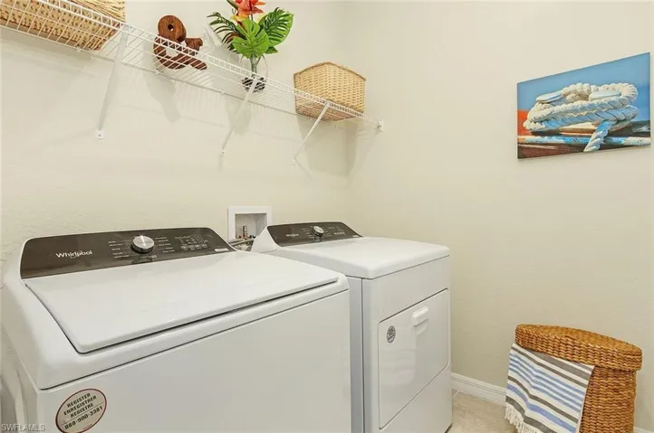 Laundry room featuring baseboards and washing machine and dryer