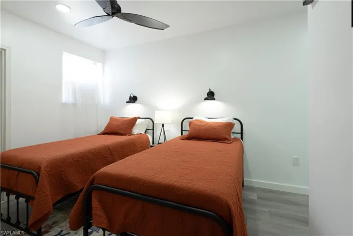 Bedroom with ceiling fan and wood-type flooring