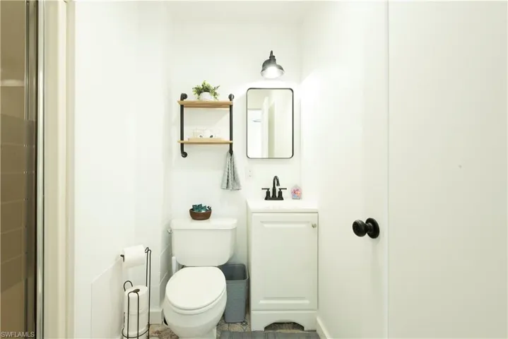 Bathroom featuring tile patterned floors, vanity, and toilet