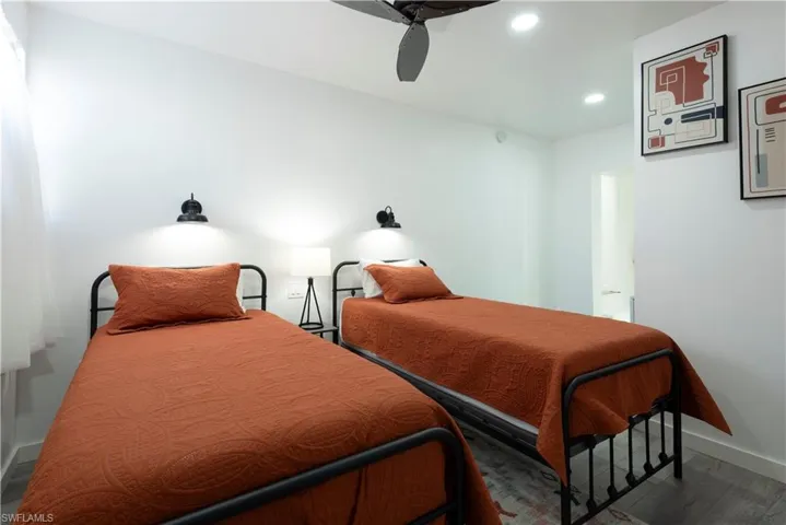 Bedroom featuring ceiling fan and dark hardwood / wood-style floors