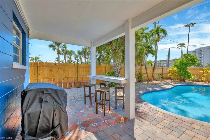 View of pool featuring grilling area and a patio area