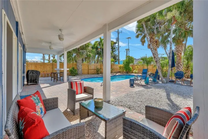 View of patio / terrace with a fenced in pool, ceiling fan, and an outdoor hangout area