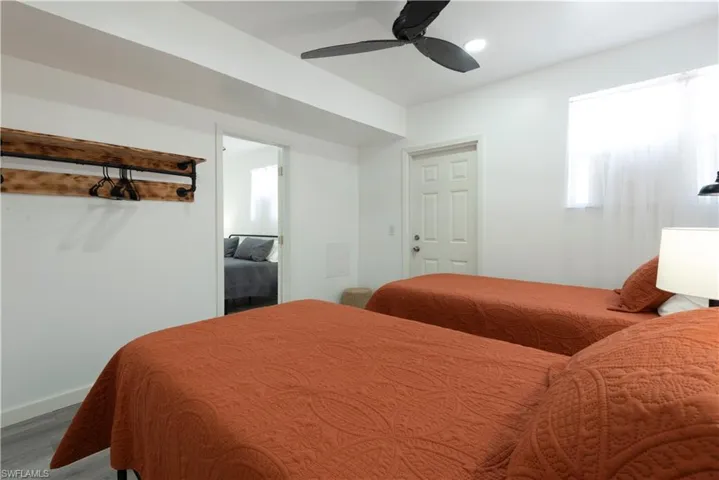 Bedroom with hardwood / wood-style floors and ceiling fan