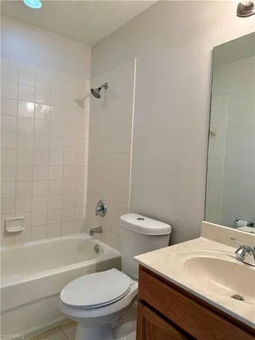 Full bath featuring vanity, bathtub / shower combination, and tile patterned floors