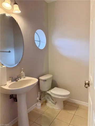 Bathroom featuring toilet and light tile patterned floors