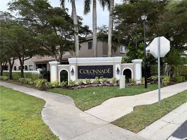Community / neighborhood sign featuring a yard