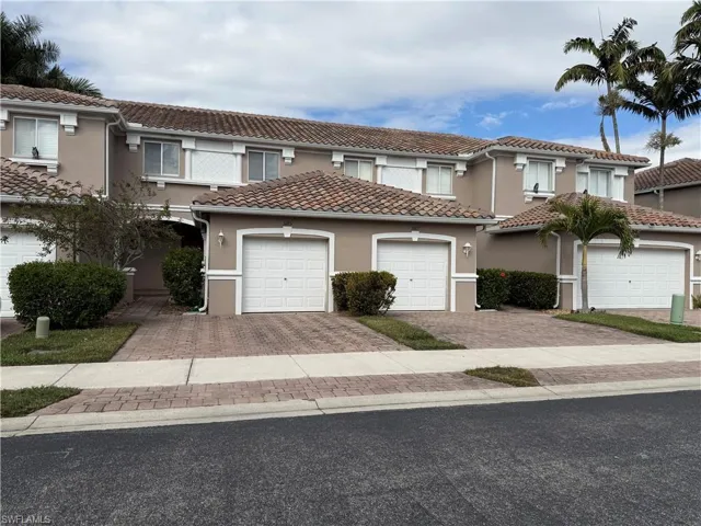 Mediterranean / spanish-style home with stucco siding, a tiled roof, and driveway