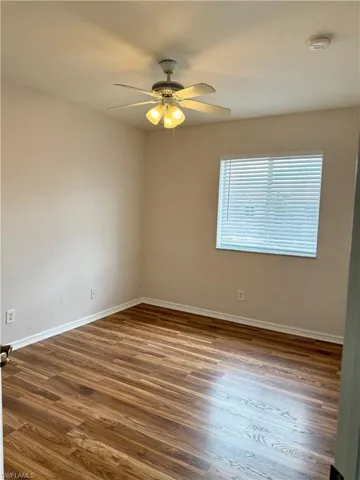 Unfurnished room featuring wood finished floors and a ceiling fan