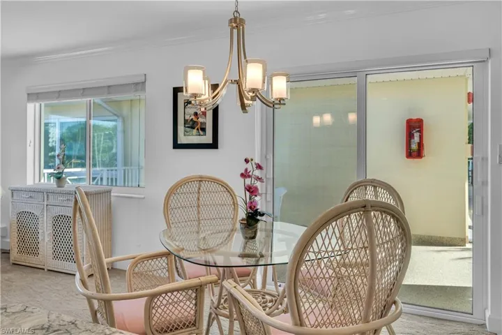 Dining space featuring a chandelier, carpet flooring, and crown molding