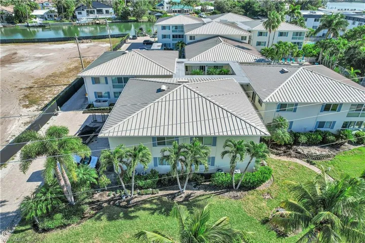 Aerial view of residential area featuring a large body of water