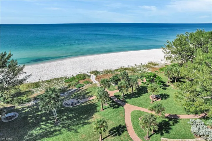 Aerial view of property's location featuring expansive beach
