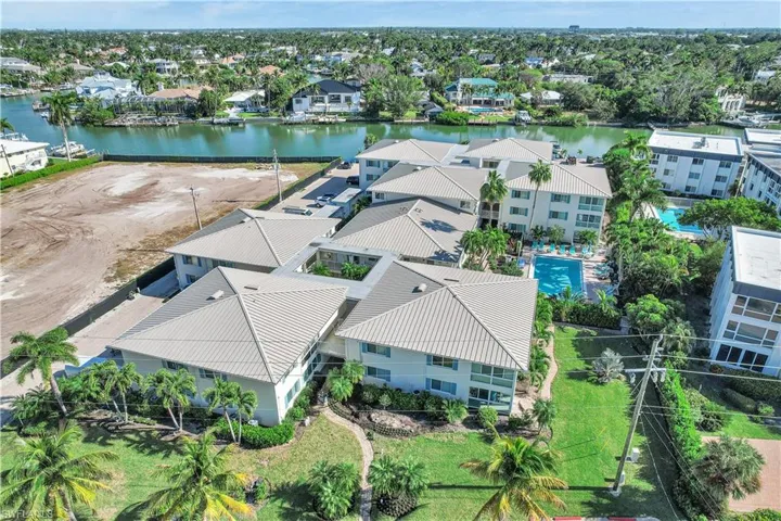 Aerial view of residential area featuring a nearby body of water