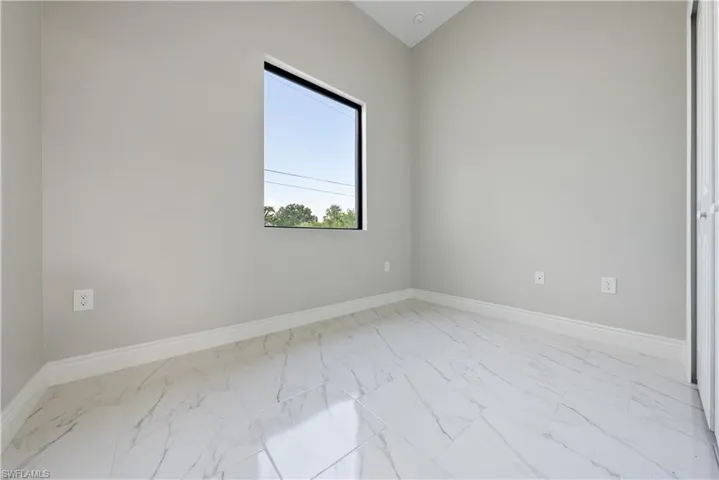 Empty room with marble finish floors and baseboards