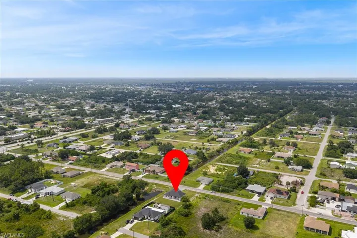 Aerial view of property's location featuring nearby suburban area