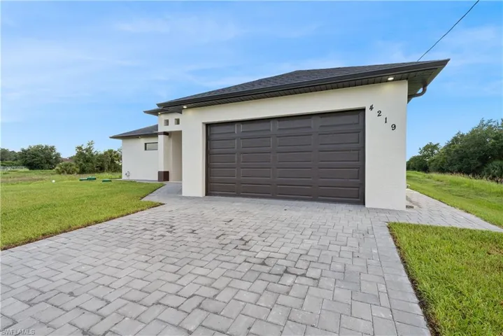 Garage featuring decorative driveway