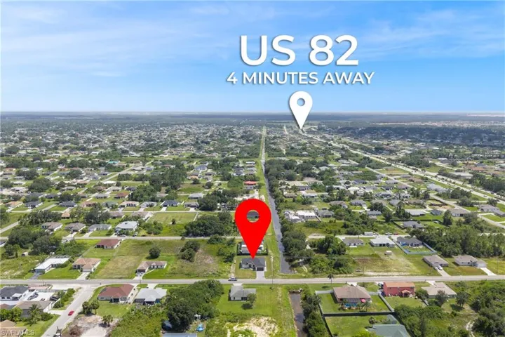 Aerial view of property's location with nearby suburban area