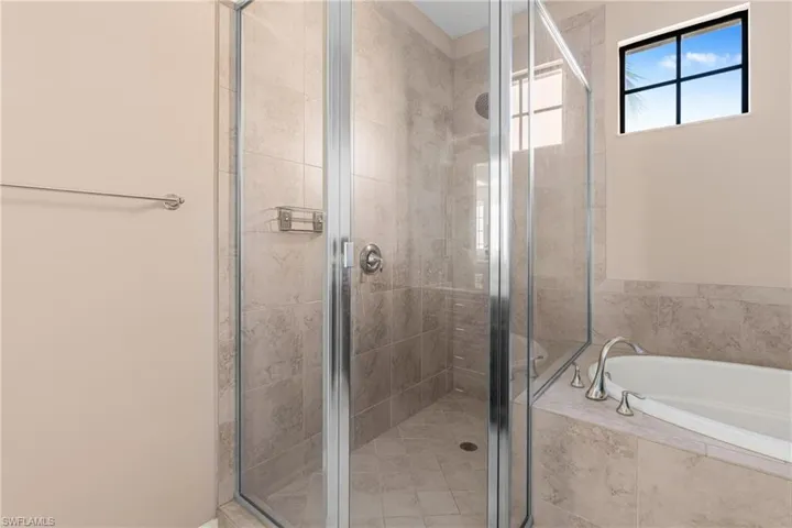Bathroom featuring a stall shower and a bath