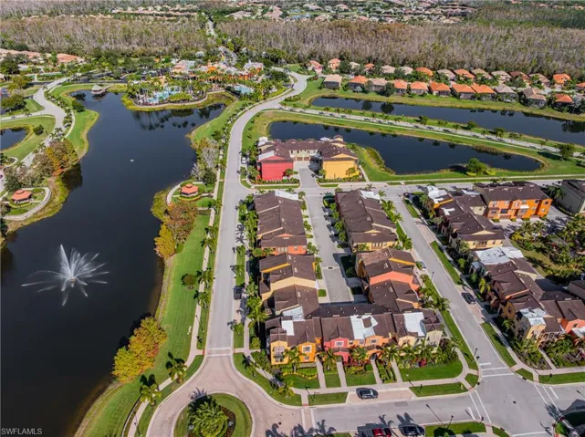 Aerial view of property's location featuring a nearby body of water and nearby suburban area