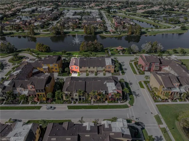 Aerial view of property and surrounding area featuring a large body of water and nearby suburban area