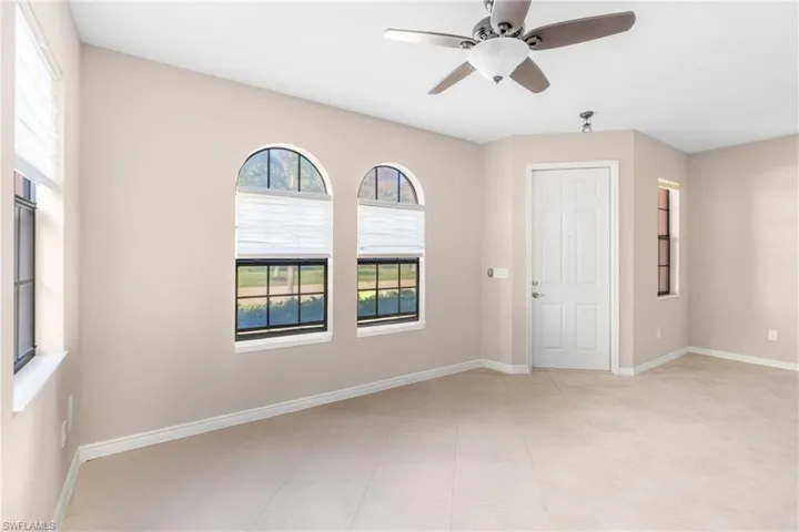 Unfurnished room featuring ceiling fan and baseboards