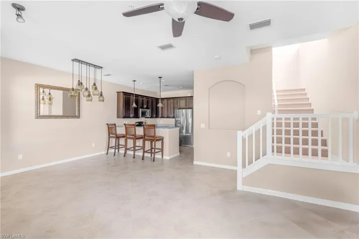 Living room featuring ceiling fan and light tile patterned floors